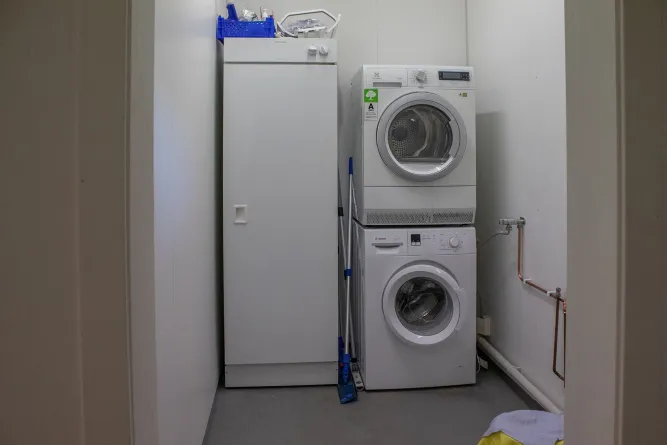 A washing machine and a dryer in a laundry room.